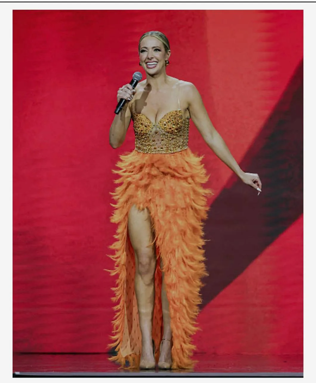 Brittany Schmitt in orange dress full body